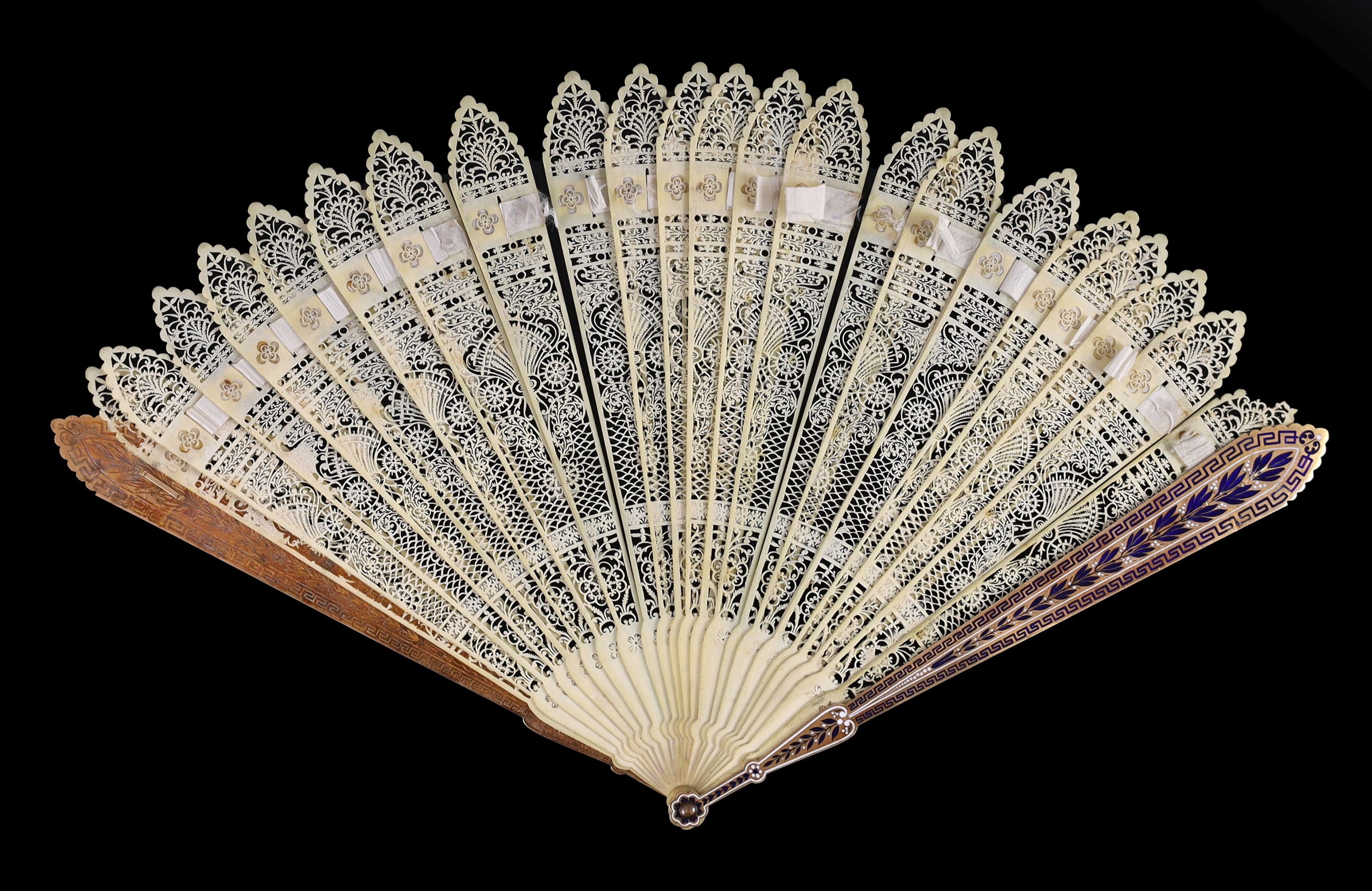 A German or Swiss gold, enamel and ivory brise fan, 19th century, possibly made for the Ottoman market, 17.3 cm closed, slight losses to sticks, needs rethreading